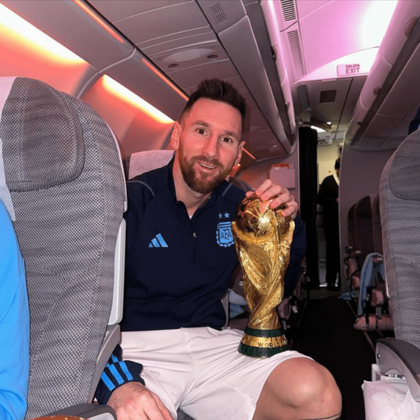 Lionel Messi on an airplane with the Trophy